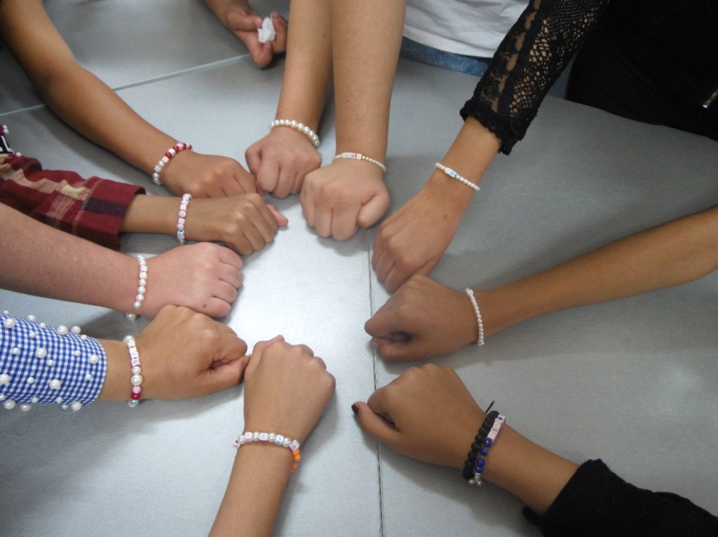 children showing their fists in a circle
